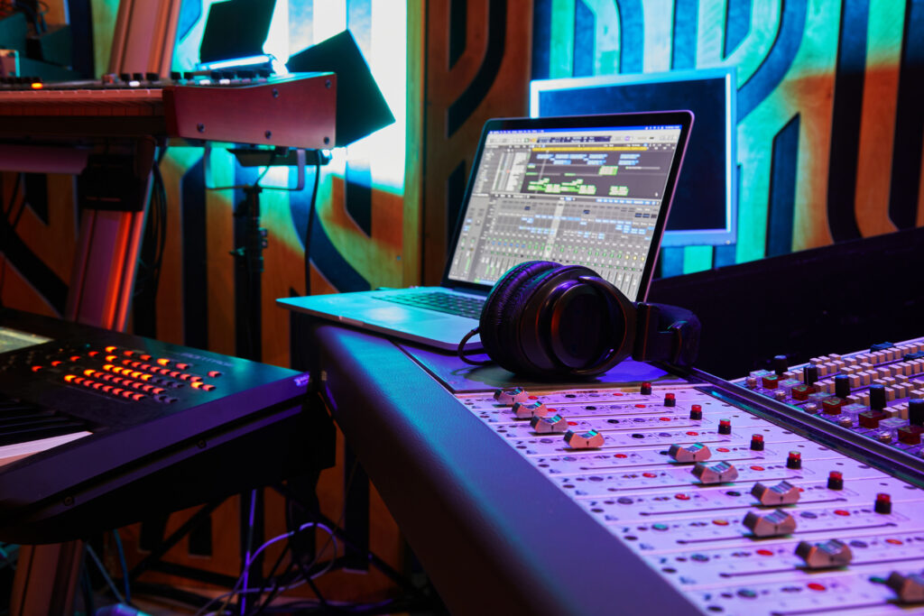 Bringing Your Passions to the Forefront - production studio interior with laptop, headphones, organ keyboard, and microphone